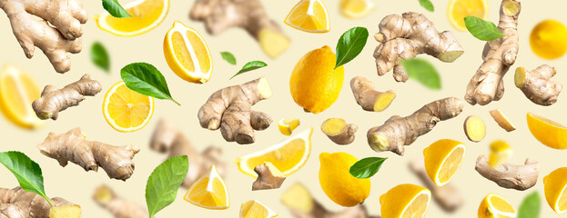 Fresh ginger root, Juicy ripe yellow lemons, green leaves flying on beige background. Creative food...