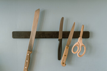 kitchen knives and scissors on a magnetic rod