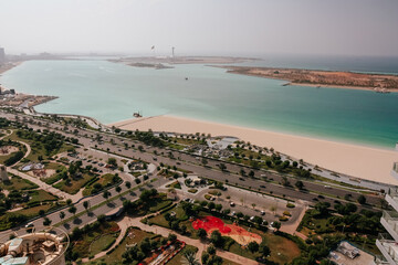 City Road, Beach and Sea Bay Beautiful Aerial View. Shoreline, Green Grass and Trees, Sandy Shoreline Landscape and Cloudy Sky on Background. Nature Panoramic Horizontal Photography