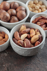 Fototapeta na wymiar Assorted nuts on a dark background