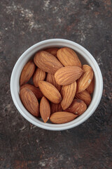 Almond nuts top view on a dark background