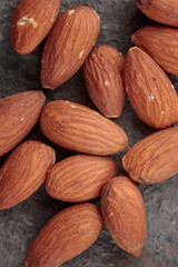 Almond nuts top view on a dark background