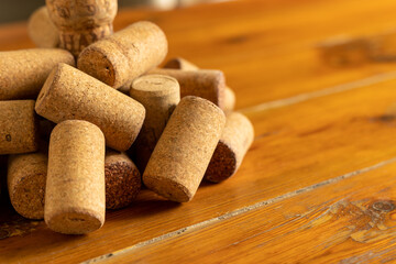 pile of used wine corks on a rustic wooden table