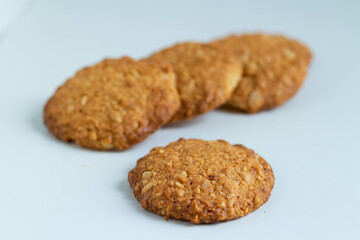 Four peanut round biscuits on a white background