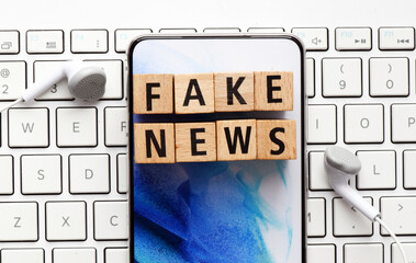 FAKE NEWS words arranged from wooden letters.