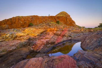 Aluminium Prints Cappuccino Colorful landscape at dawn with rocks consisting of red layers of Jasper and little pond in the vicinity of the village of Marble Bar, Western Australia