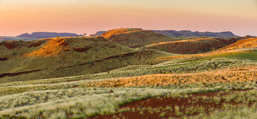 Panorama image of a semi-desert landscape with hills and table mountains in Millstream Chichester National Park at sunset, Pilbara, Western Australia - obrazy, fototapety, plakaty