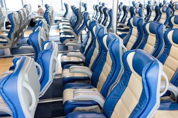 Ferry over ocean. Interior of a ship with empty passengers seats and sea view. High quality photo
