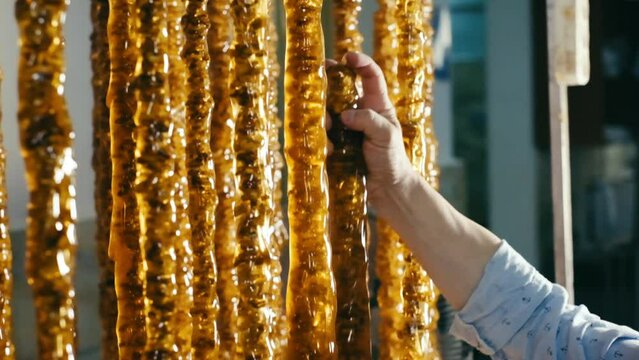 Churchkhela is a traditional Georgian cuisine candle-shaped candy. Traditional Georgian dessert in the form of sausage. 4K video.slow motion.