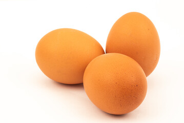 The Netherlands, February 2022. A carton of eggs with feathers on a white background.