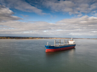 Cargo ship, bulk carrier, anchored near the Port of Montreal on the St. Lawrence River.