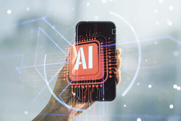 Double exposure of creative artificial Intelligence abbreviation and hand with cellphone on...