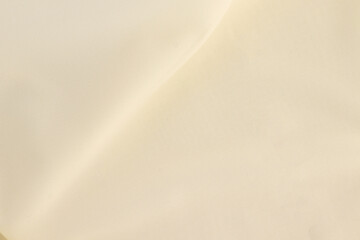 Obraz na płótnie Canvas Smooth elegant creamy white silk or elegant satin texture can be used as background, elegant wedding background design.