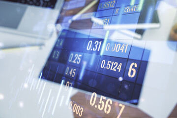 Abstract creative financial graph and modern digital tablet on desktop on background, top view, financial and trading concept. Multiexposure