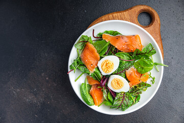salad salmon, egg, green leaves lettuce fresh portion healthy meal food diet snack on the table copy space food background 