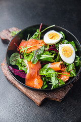 salad salmon, egg, green leaves lettuce fresh portion healthy meal food diet snack on the table copy space food background 