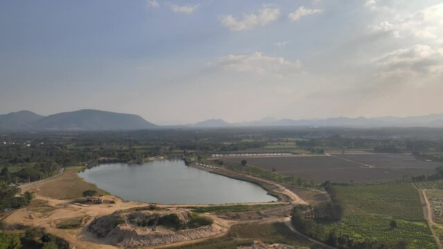 Beautiful Aerial Scenery of a Lake at a Resort in Phetchaburi, Thailand with Blue Skies.
