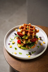 Belgian cheese waffles with guacamole, tomato and syrup