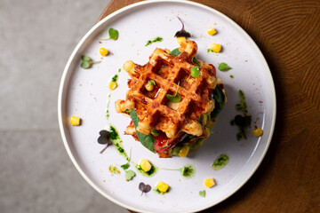 Belgian cheese waffles with guacamole, tomato and syrup