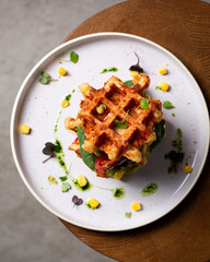 Belgian cheese waffles with guacamole, tomato and syrup