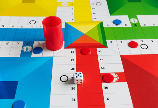 Classic Parcheesi game board with tokens and dice