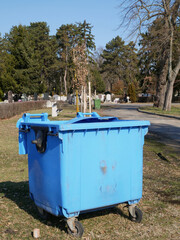 Fototapeta na wymiar Large garbage can in the public cemetery