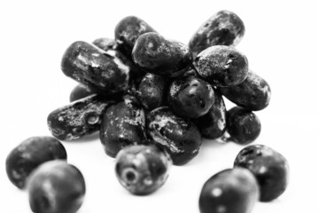 Black grapes with drop of water isolated on white background in low light