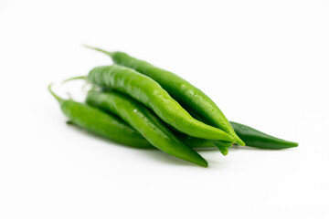 Fresh green chilies close up on white background