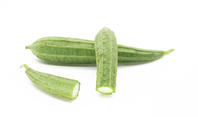 Angled luffa or Ridge gourd slice over on white background, selective focus