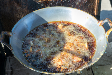 Chef cooking crispy fried chicken in the big pan to Chinese banquet food preparation. fat from trans-fat concept. Disease from cholesterol and Trans-fatty concept. 