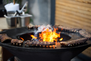 Grilled pork baby ribs with barbecue sauce on the grill. Festival street food