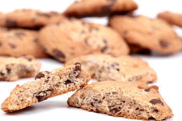 Homemade cookies with small pieces of chocolate in composition on white background.