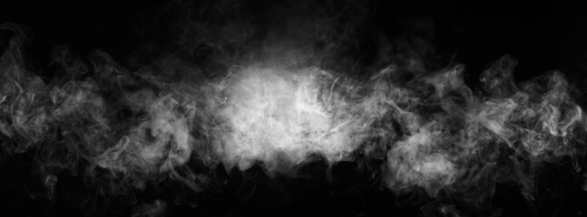 Abstract smoke texture over black. Fog in the darkness.