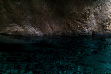 clean underground cave river in steep stone banks in the dark