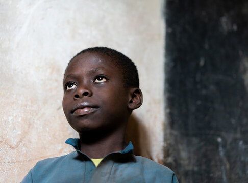 Close-up Portrait Of African Black Boy Portrait Inside Of School Classroom. High Quality Photo