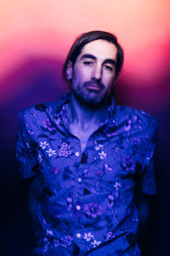 Serious man in studio with glowing light