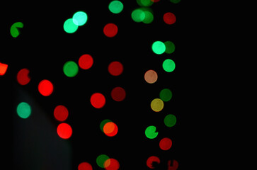 closeup the red green lighting bubbles over out of focus black background.