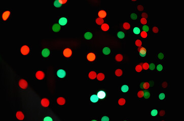 closeup the red green lighting bubbles over out of focus black background.