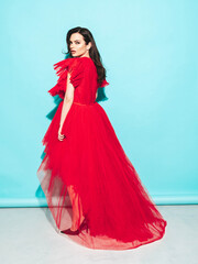 High fashion portrait of young beautiful brunette woman wearing nice trendy red evening fluffy...