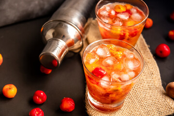 Acerola(Barbados Cherry) Caipirinha, Traditional alcoholic drink from Brazil in Dark background.