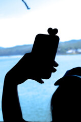 silhouette of person and phone
