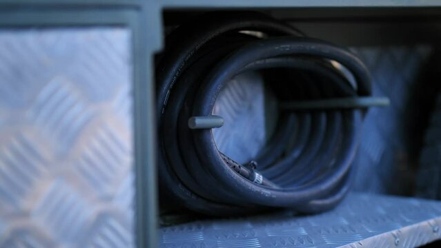 View of Connecting Electricity wire roled up to a side of a RV camper van. Motor van Features.