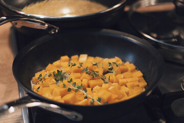 Pumpkin cubes in a pan with thyme