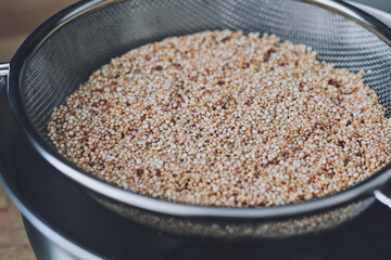 Quinoa in a metal strainer