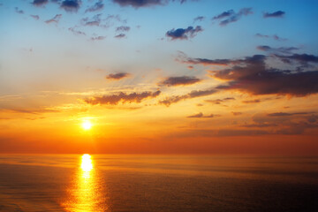 Fototapeta premium Beautiful sunrise over the quiet calm sea.