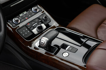 Gear shift lever for automatic transmission. Engine start button close up. Elements of a luxury...