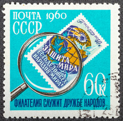 RUSSIA - CIRCA 1960: A stamp printed by Russia, shows Stamp of 1957 Under Magnifying Glass, circa...