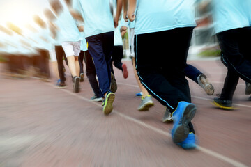Obraz premium Group of students running on a racing track.