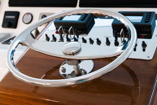 Motor yacht control panel. Steering wheel and gear levers.