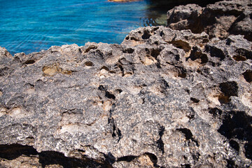 View of the calm sea from the height of the mountains. Beautiful seascape. Travel to the mountains. Summer rest. Rocks, cliffs, stones.